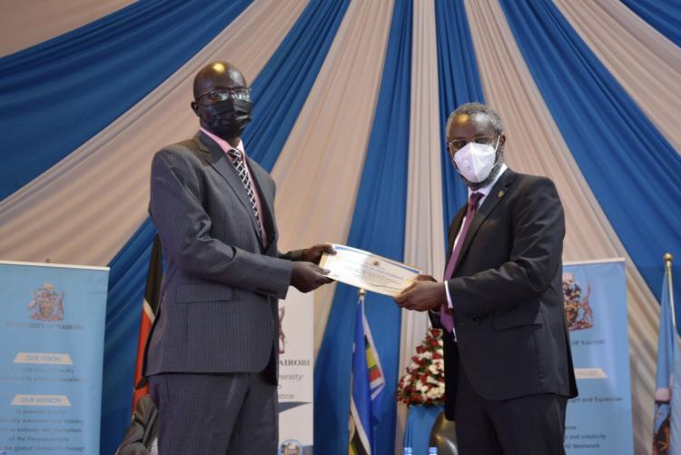 CASELAP Director, Dr Collins Odote receiving a certificate from UoN VC Prof. Stephen Kiama .